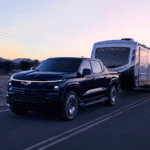 Chevrolet Silverado EV towing a trailer at dusk