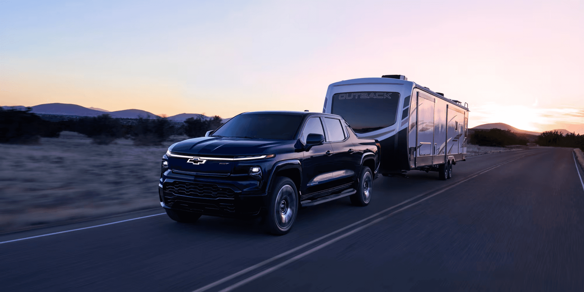 Chevrolet Silverado EV towing a trailer at dusk