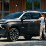 Couple packing 2026 Chevy Tahoe in driveway