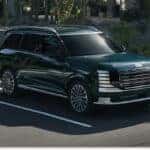Dark green 2026 Hyundai Palisade SUV parked in a parking lot, shown from a front three-quarter view.