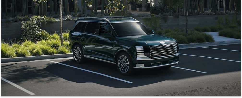 Dark green 2026 Hyundai Palisade SUV parked in a parking lot, shown from a front three-quarter view.