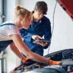 Mechanics in Racine, WI checking the engine of a vehicle to diagnose an issue
