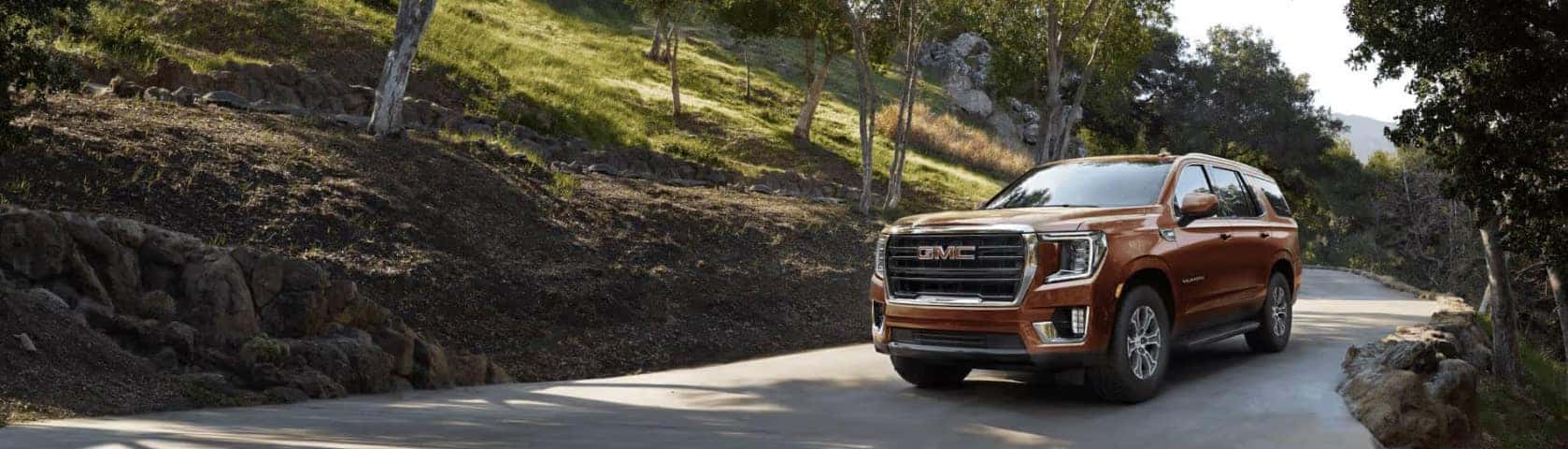 Brown GMC SUV on the road