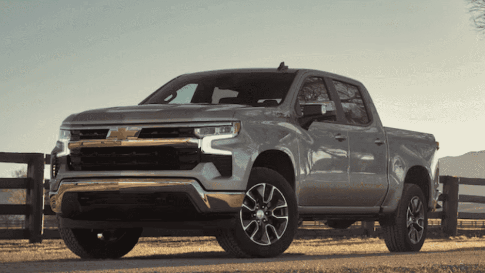 Exterior front three-quarter view of a 2026 Chevrolet Silverado parked outdoors with bold grille styling and alloy wheels