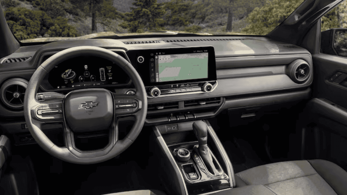 Interior dashboard of a 2026 Chevrolet Colorado showing the steering wheel, digital instrument cluster, and touchscreen infotainment system