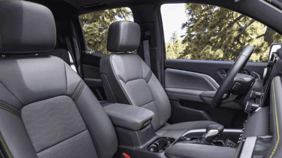 Front interior seating of a 2026 Chevrolet Colorado featuring supportive front seats, center console, and modern cabin materials