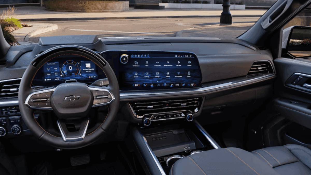 Interior front cabin of a 2026 Chevrolet Tahoe featuring a wide digital display, premium dashboard layout, and spacious design