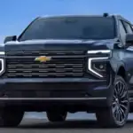 Front view of a 2026 Chevrolet Tahoe parked near open water, highlighting full-size SUV space and towing capability for families near Ruth, NC