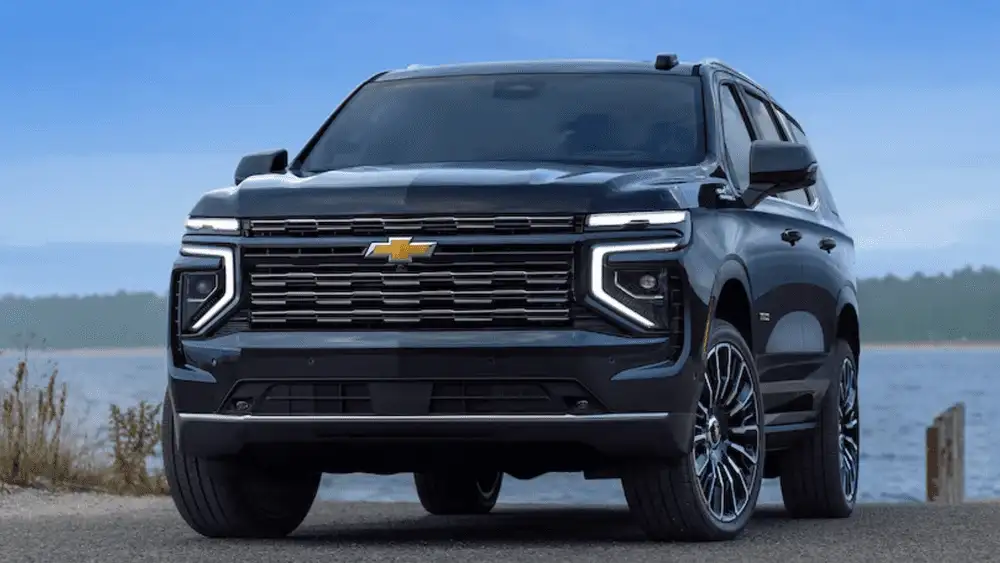 Front view of a 2026 Chevrolet Tahoe parked near open water, highlighting full-size SUV space and towing capability for families near Ruth, NC