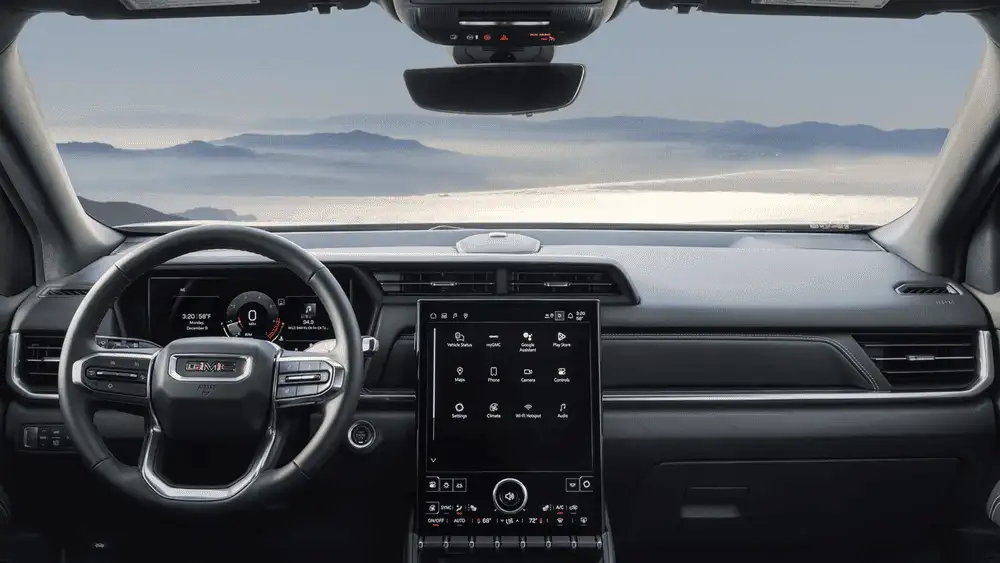 Interior driver view of a 2026 GMC Terrain showing the steering wheel, digital gauge cluster, and vertical touchscreen display near Ruth, NC