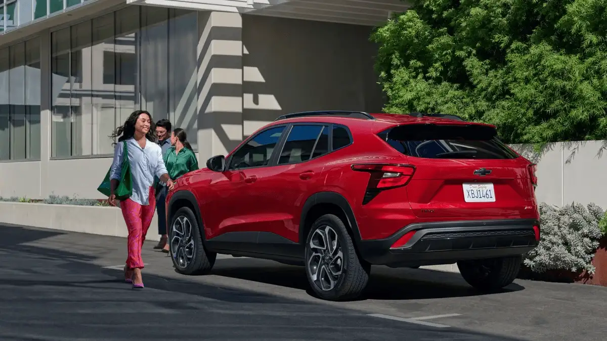 Rear three-quarter view of 2026 Chevrolet Trax near Ruth, NC parked curbside, highlighting sleek taillights and urban-friendly SUV design