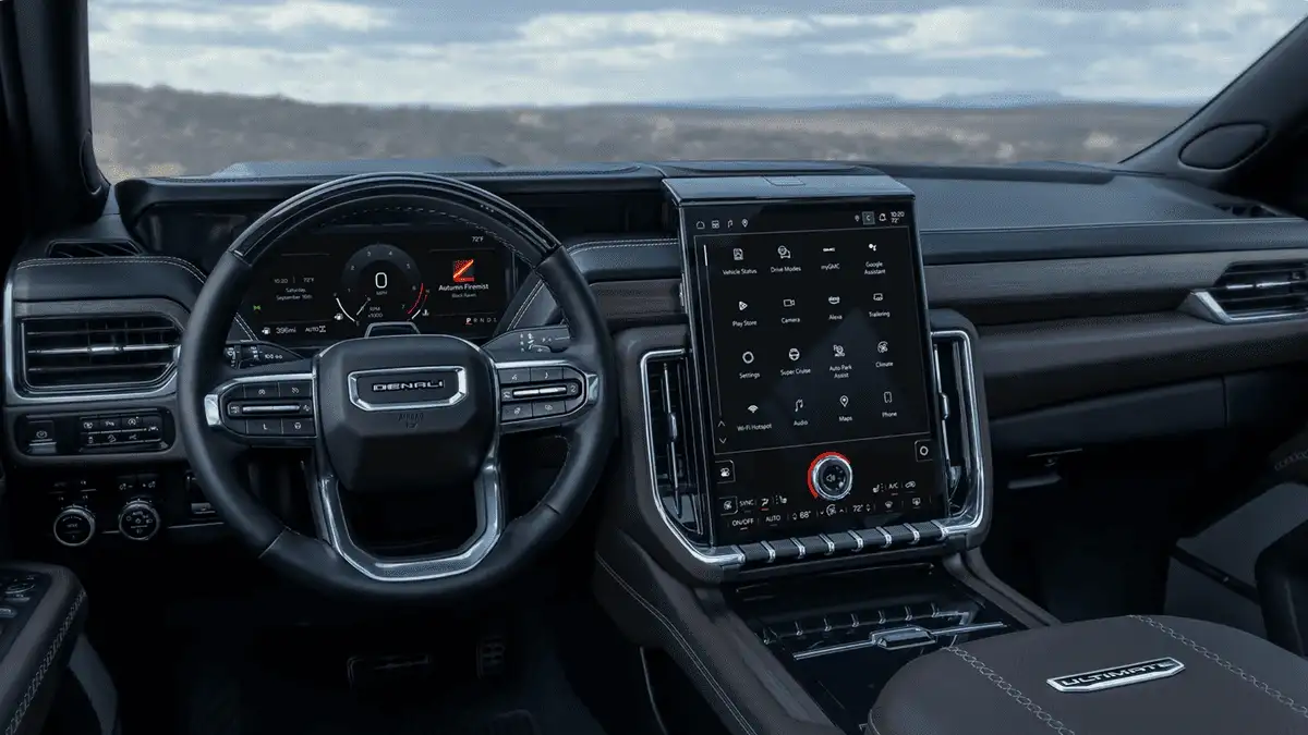 Interior cabin of 2026 GMC Yukon near Ruth, NC featuring large vertical touchscreen, digital gauge cluster, and premium Denali finishes