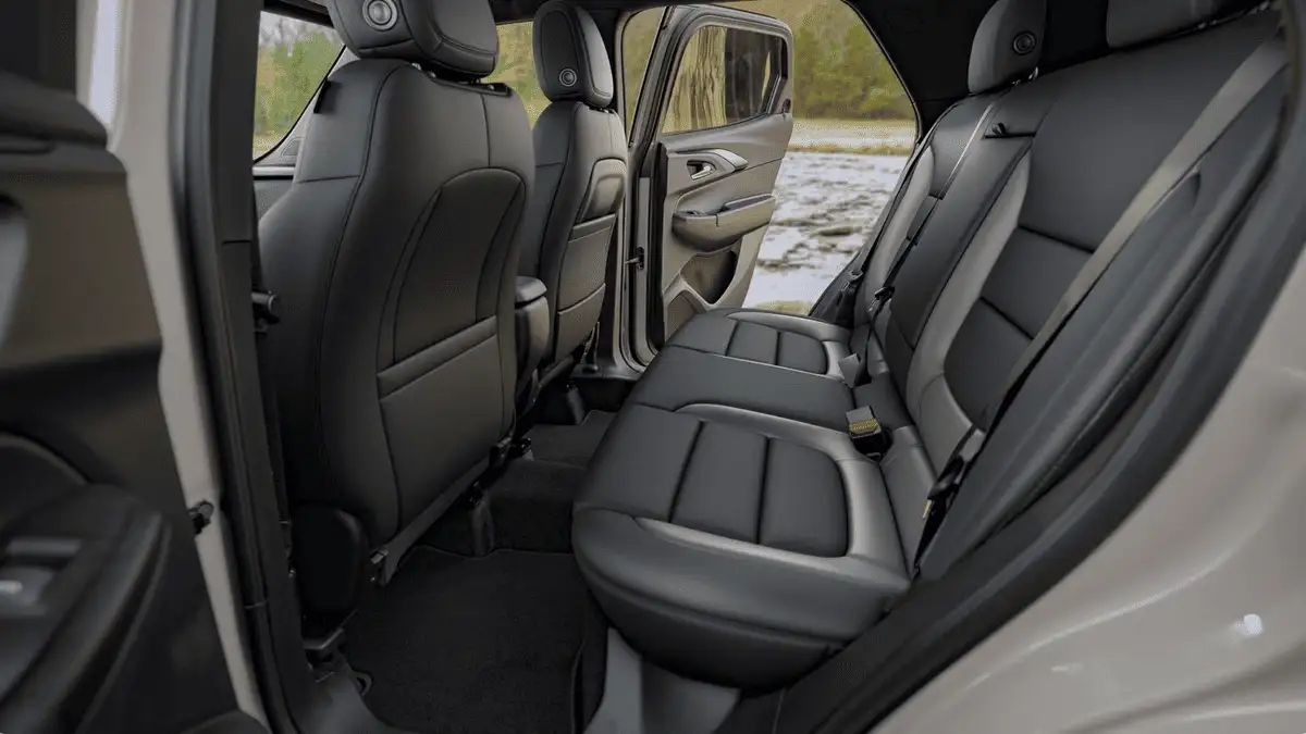 2026 Chevrolet Trailblazer rear passenger cabin near Ruth NC showing spacious black leather back seats with open door and wooded landscape in background