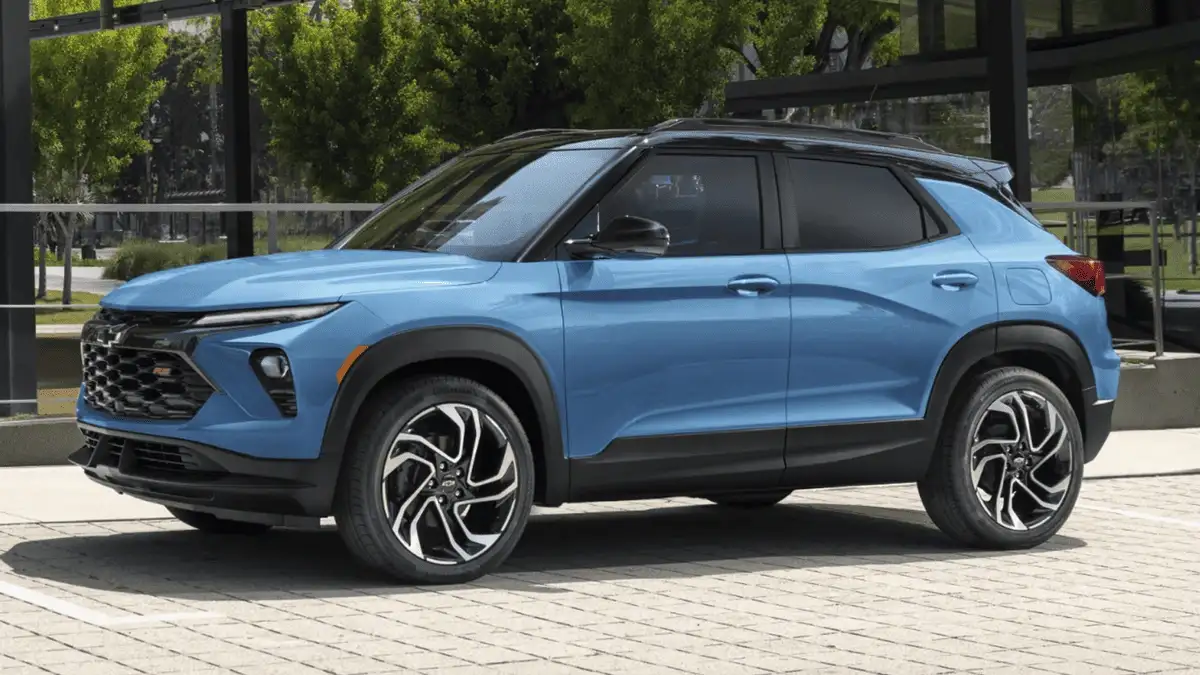 2026 Chevrolet Trailblazer RS near Ruth NC in bright blue with black roof, bold front grille, and two-tone alloy wheels parked on urban plaza