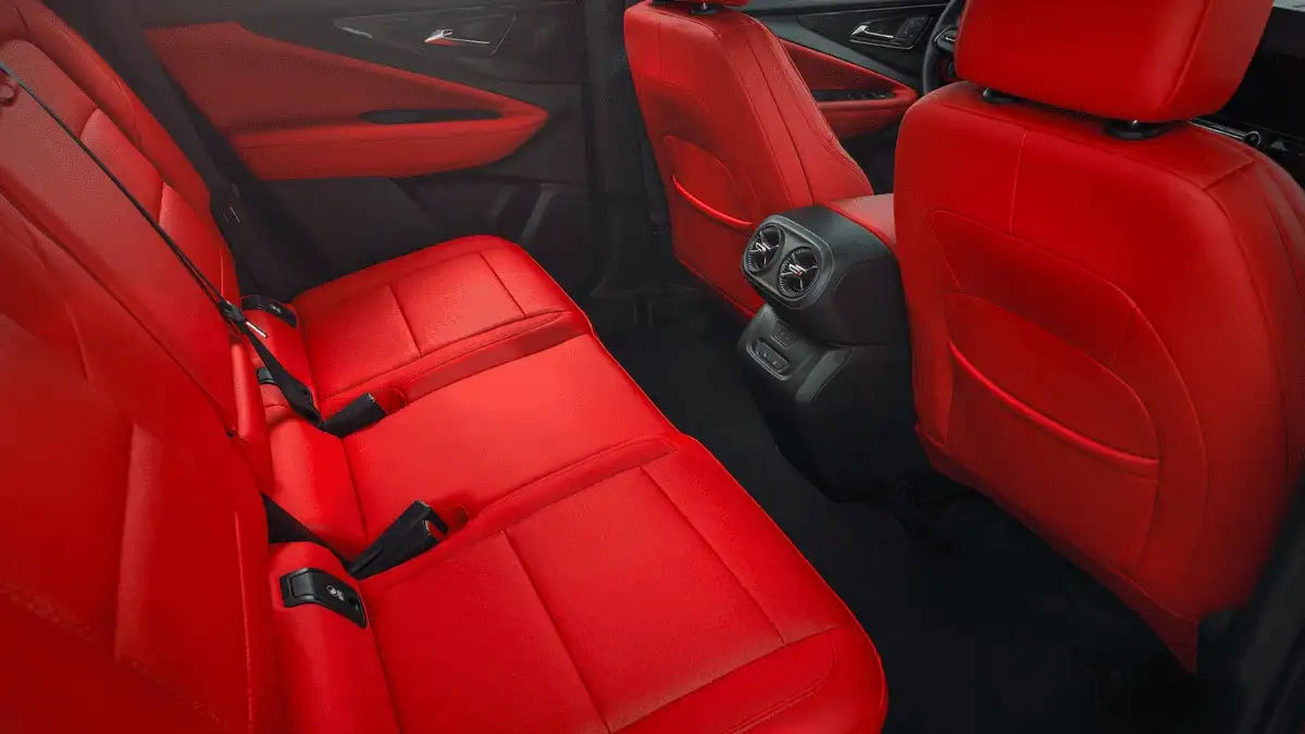 2026 Chevrolet Blazer EV rear passenger seating near Ruth NC with bold red leather upholstery, rear seat air vents, and seatbelts visible
