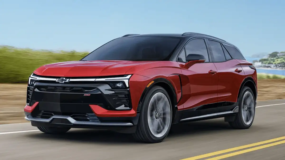 2026 Chevrolet Blazer EV near Ruth NC in red and black two-tone finish driving on open road with SS badging and sleek aerodynamic SUV profile