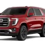 Big SUV battle featuring the 2026 GMC Yukon XL around Ruth NC in deep crimson red with chrome GMC grille lettering, LED headlights, Yukon XL badging, and split-spoke alloy wheels on white studio background