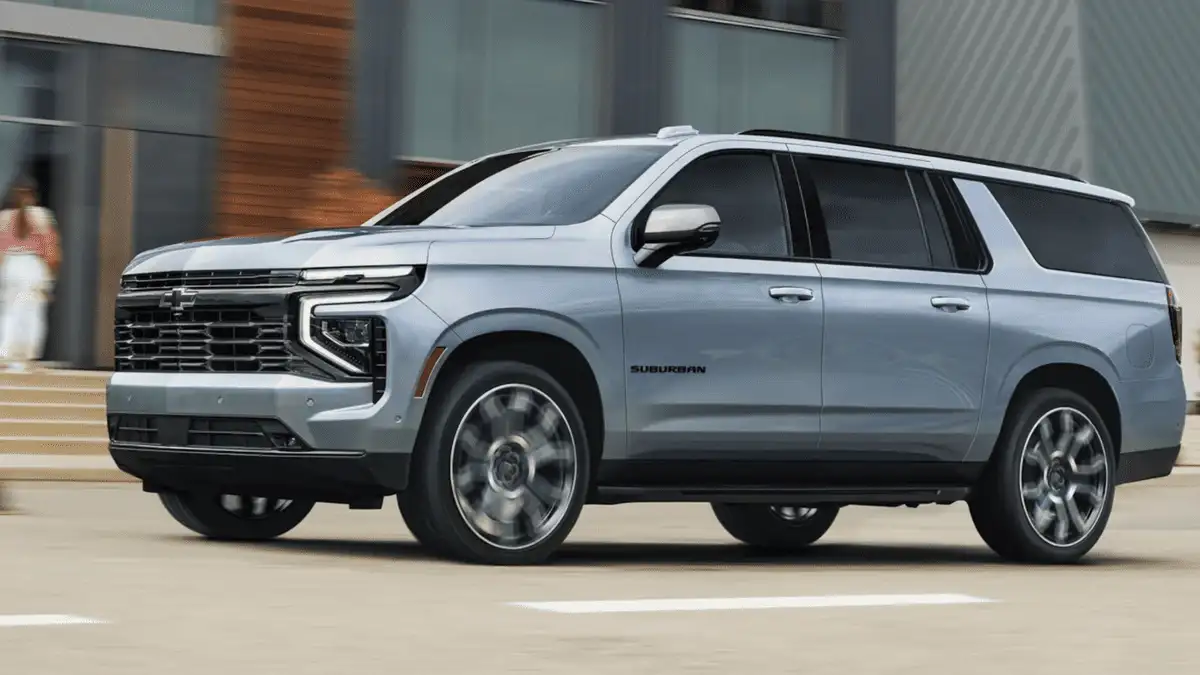 Big SUV battle featuring the 2026 GMC Yukon XL around Ruth NC in deep crimson red with chrome GMC grille lettering, LED headlights, Yukon XL badging, and split-spoke alloy wheels on white studio background