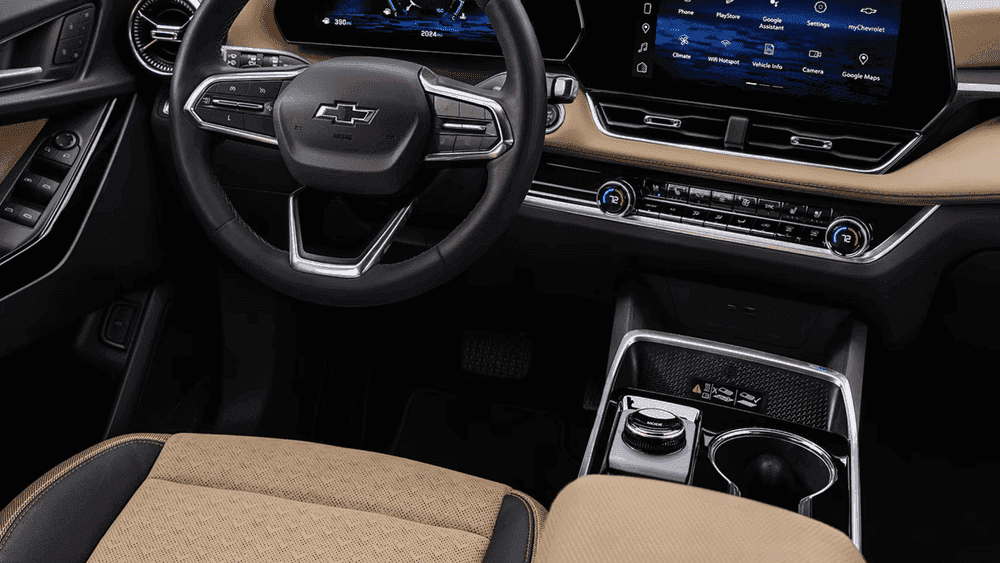 2026 Chevrolet Equinox RS front seat interior near Ruth NC featuring black and red leather bucket seats with RS headrest embroidery, red accent stitching, center armrest, and cup holders