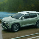 New this year the 2026 Chevrolet Equinox near Ruth NC in sage green with white roof, Equinox badging, Bowtie grille, and dark alloy wheels driving along a lakeside highway