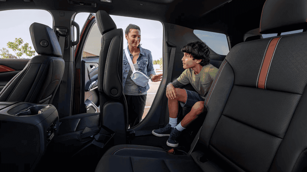 2026 Chevrolet Traverse rear cabin near Ruth NC with three-row black leather seating and red stitching
