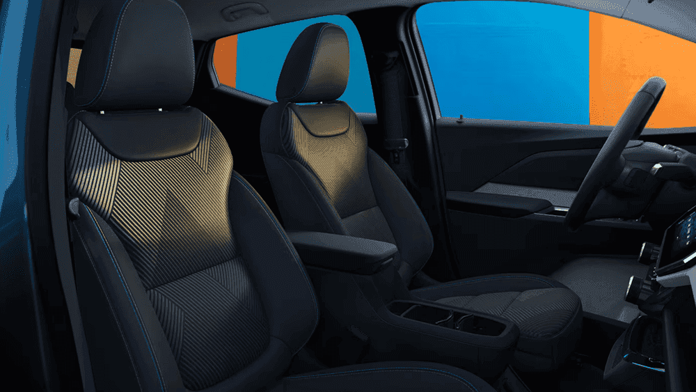2027 Chevrolet Bolt front seat interior near Ruth NC with patterned black and gold fabric seats and blue stitching