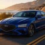 2026 Genesis G70 in Verbena Blue on winding coastal road at golden hour — Genesis of Schererville, Northwest Indiana