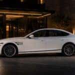 2026 Genesis G80 in Uyuni White parked at luxury hotel entrance at night — Genesis of Schererville serving Schererville, Merrillville, and Northwest Indiana