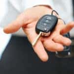 Car Keys. Seller hand giving keys