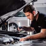 Genesis service technician working on a car