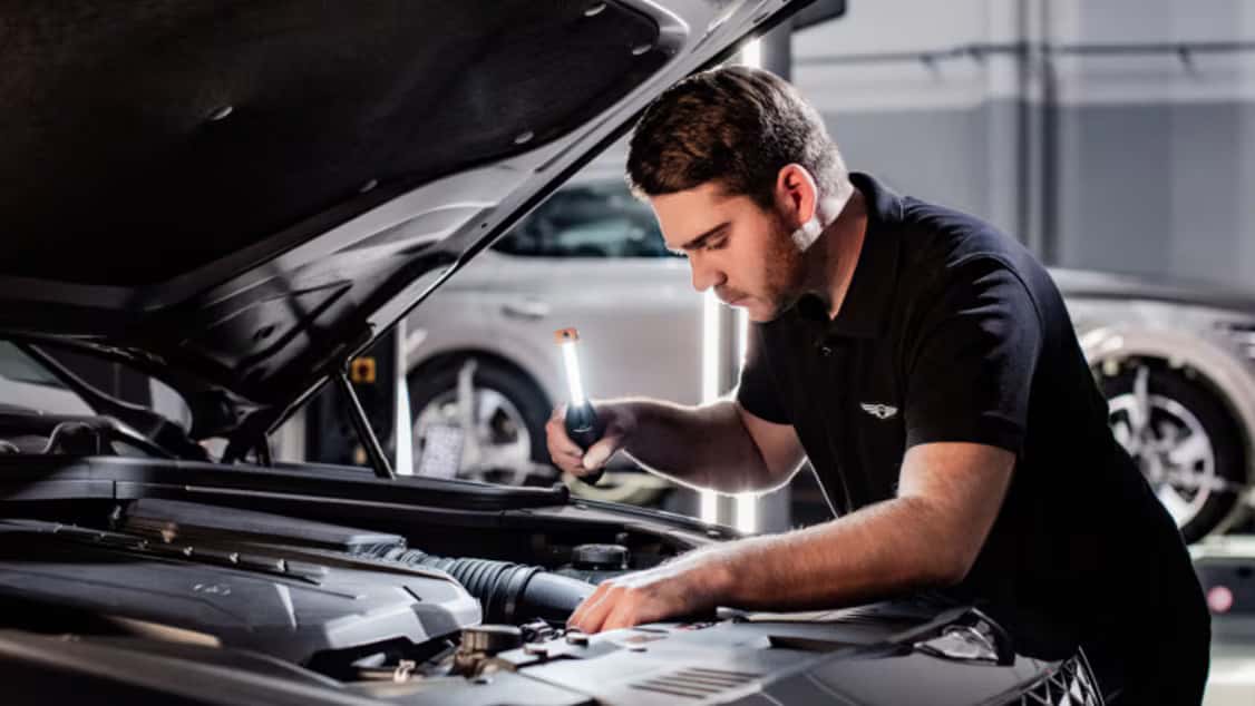 Genesis service technician working on a car