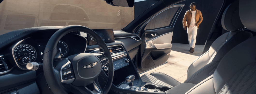 Interior 2026 Genesis G70 with door open and man seen walking to vehicle.