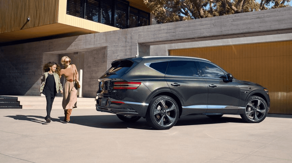 2026 Genesis GV80 parked outside modern home.
