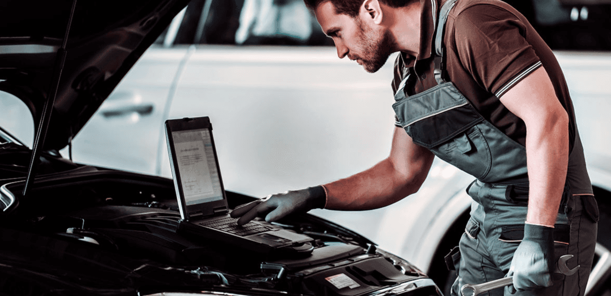 Genesis technician under hood.
