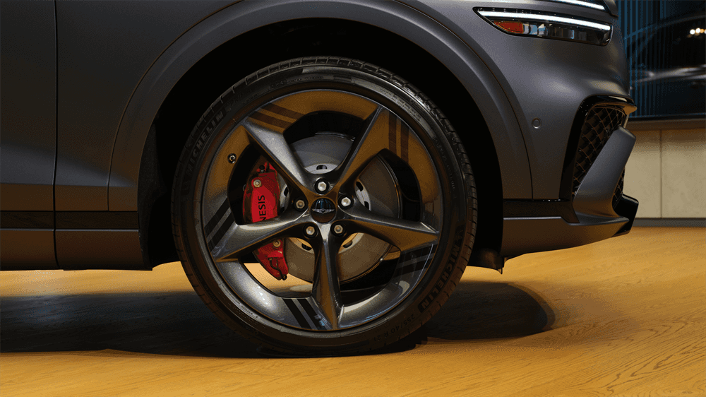 2027 Genesis GV70 alloy wheel with red brake caliper