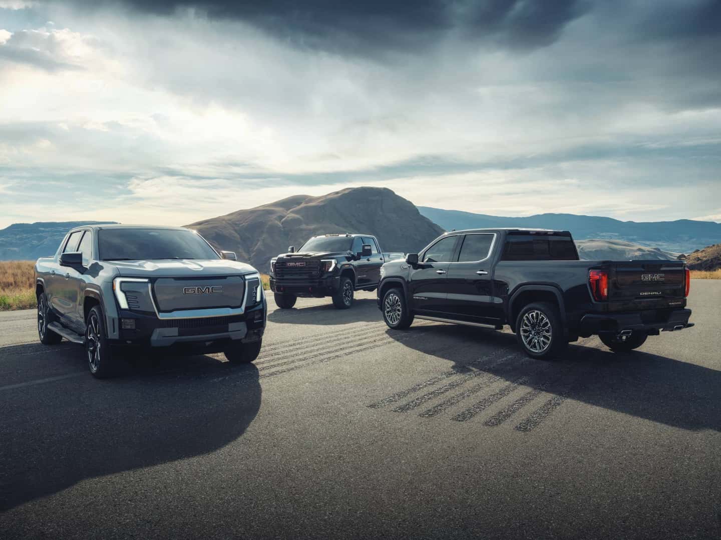 2024 GMC Denali driving down a road