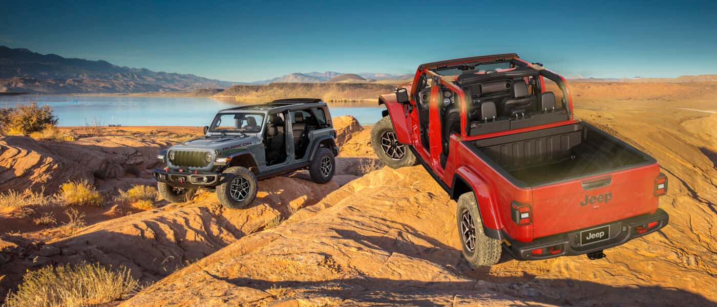 2026 Jeep Gladiator parked with Wrangler on rocks