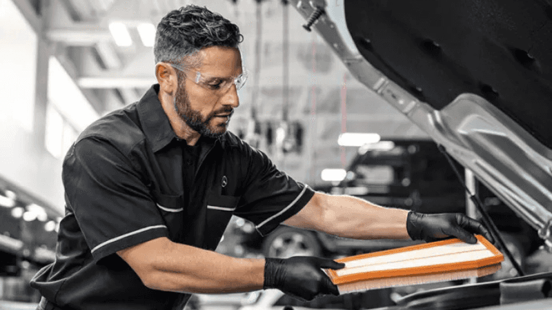 Mercedes-Benz Air Filter Service Mercedes-Benz technician replacing an air filter during scheduled maintenance