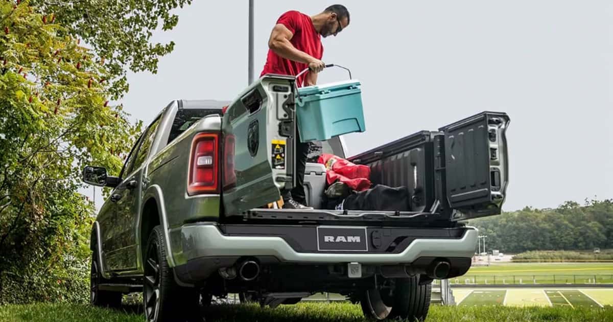 Man loading a Ram 1500 truck bed