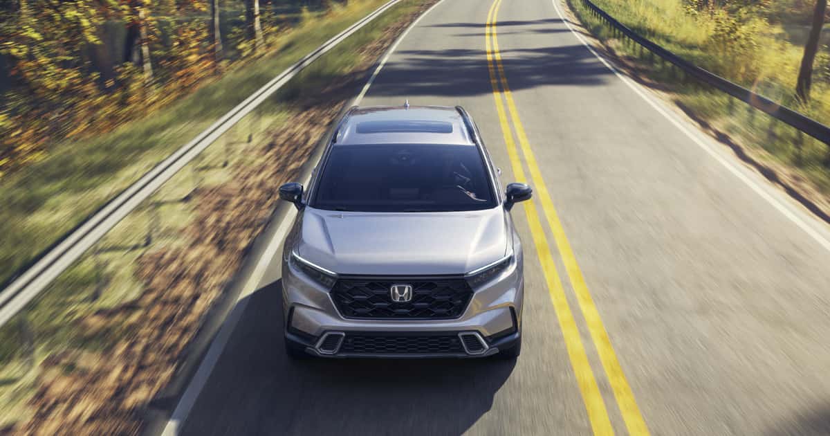 A silver 2026 Honda CR-V Hybrid on the road.