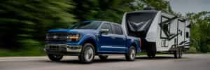 ford f-150 towing down the road