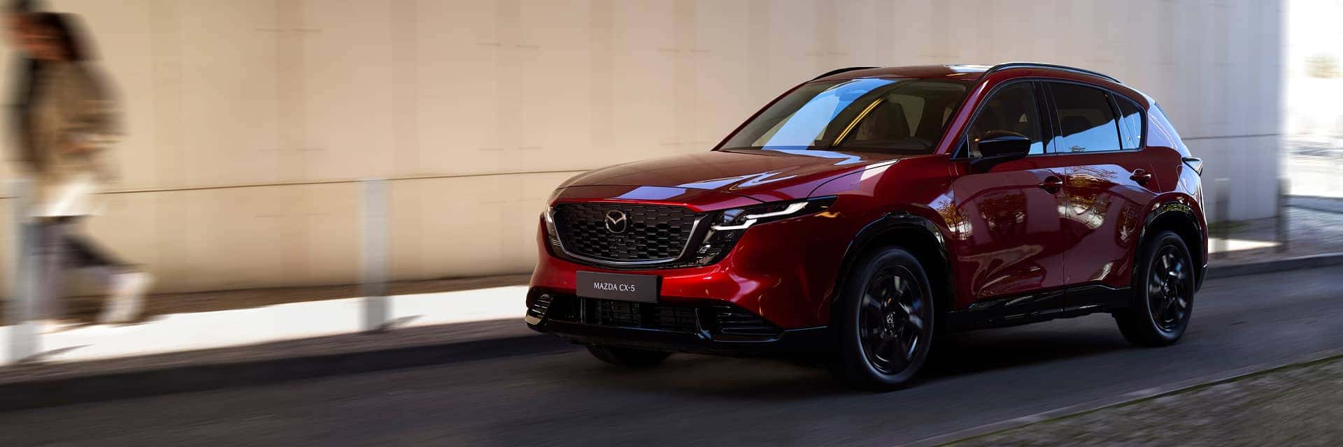 red mazda cx-5 driving on road