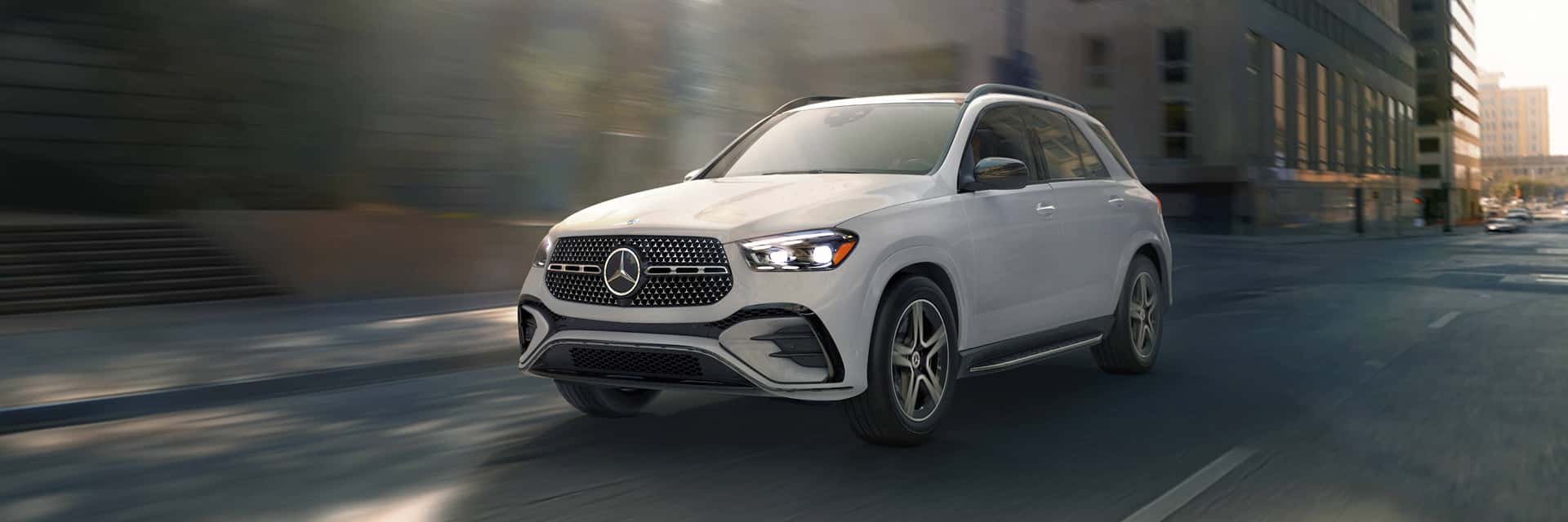 white 2026 mercedes-benz gle driving on road