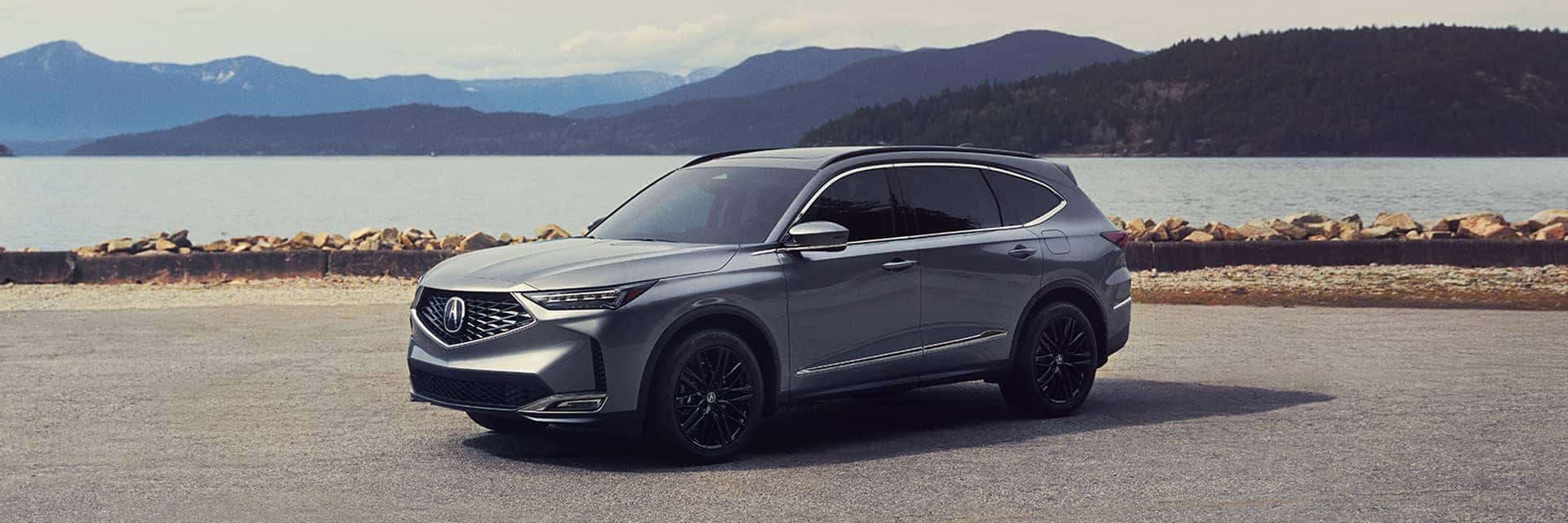 2026 acura mdx parked in front of water and mountains