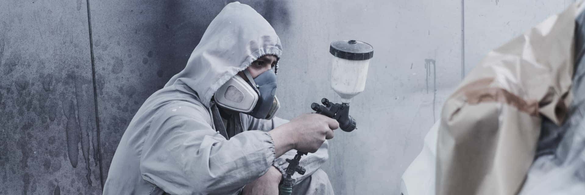 Body Shop technician spraying a car
