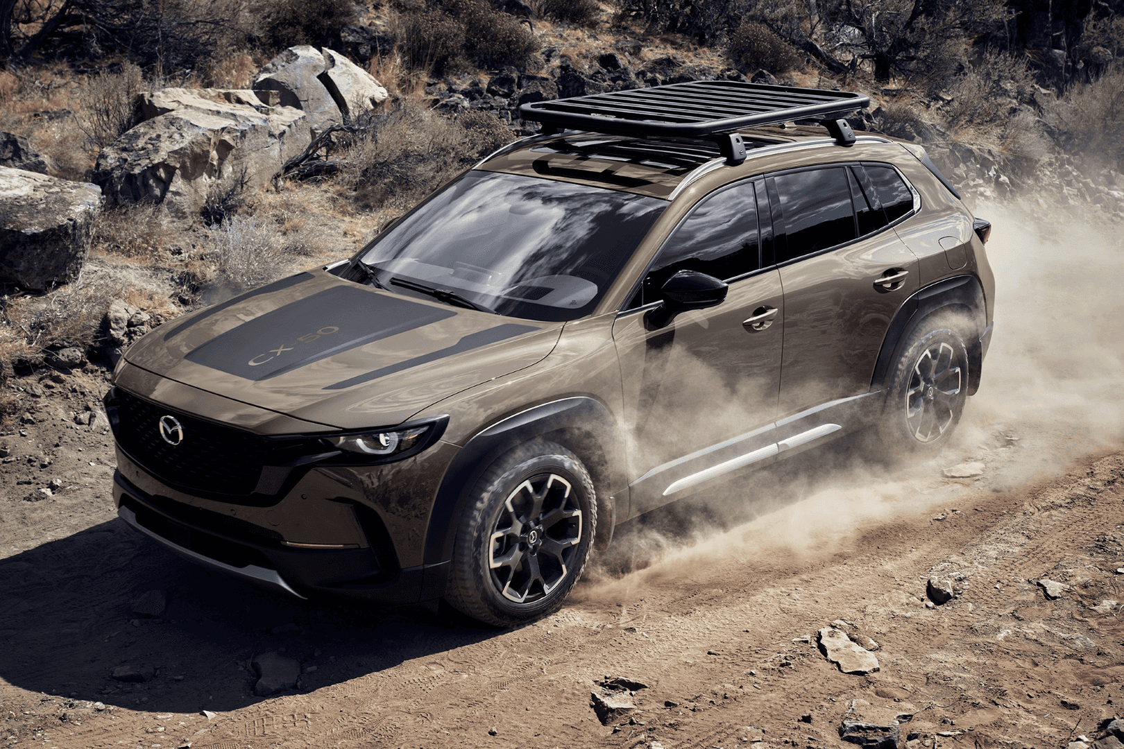 2026 Mazda CX-50 Hybrid driving in the dirt