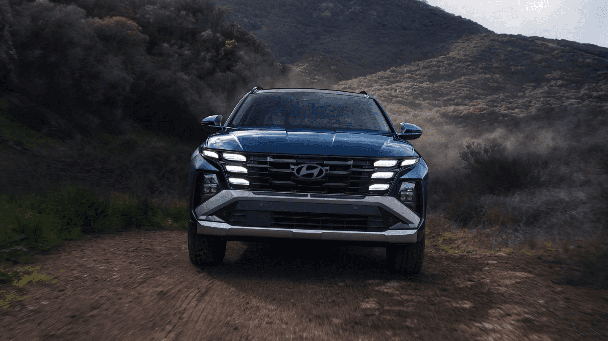 Front view of the 2026 Hyundai Tucson Hybrid on a dirt road