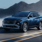 Front and side view of the 2026 Hyundai Tuson Hybrid with mountains in the background
