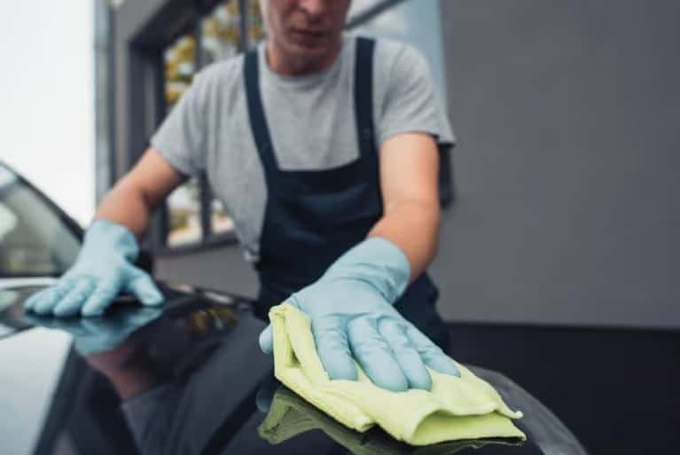 Technician wiping a hood