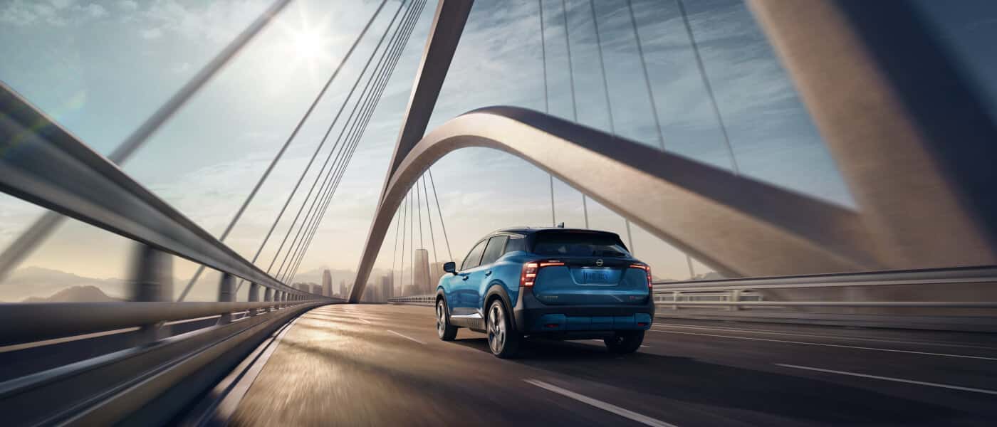 2026 Nissan Kicks Exterior Driving Away On Bridge